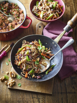 Chilli California Walnut stir fry recipe with stir fry in bowl with spoon and pot of vegan mince