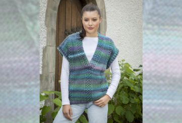 Brown haired woman model wearing bright cool toned knitted overtop with white long sleeved shirt underneath