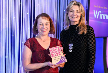 Angela holding the PPA Award next to presenter Jo Caulfield