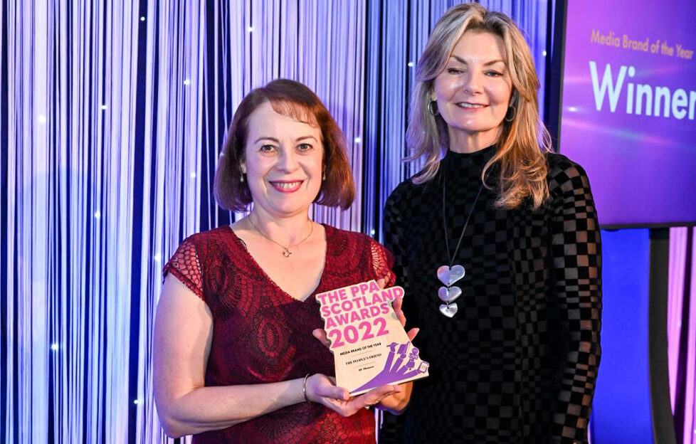 Angela holding the PPA Award next to presenter Jo Caulfield