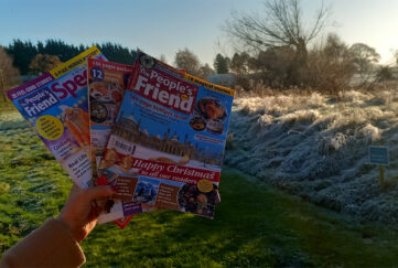 Holding The People's Friend magazine at a sunlit frosty countryside at Alvaston Hall