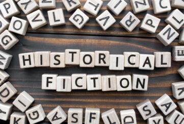 Letter tiles spelling out 'historical fiction' on a table