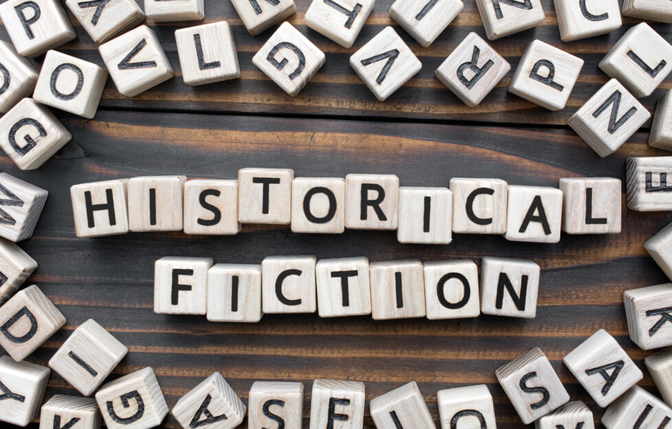 Letter tiles spelling out 'historical fiction' on a table