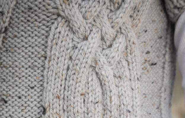 Close up macro photo of celtic pattern knit in the gilet