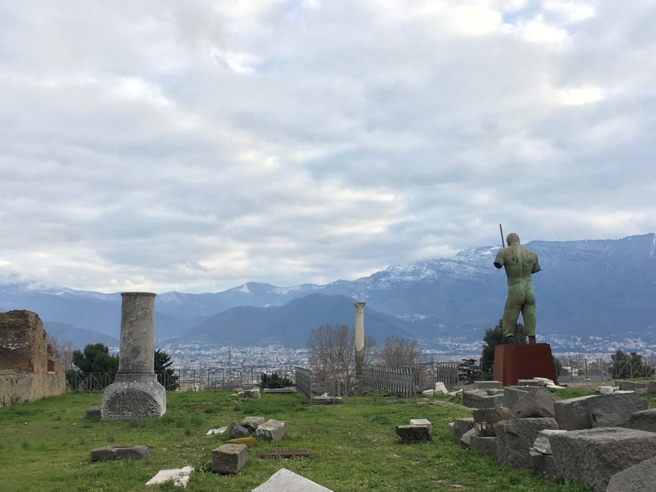 Image of the city of Naples taken from Pompeii Archaeological Park with the mountains behind it