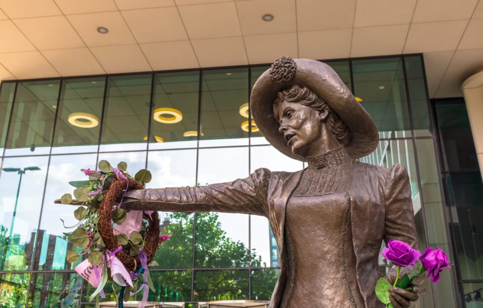 Statue of Emmeline Pankhurst holding pink flowers