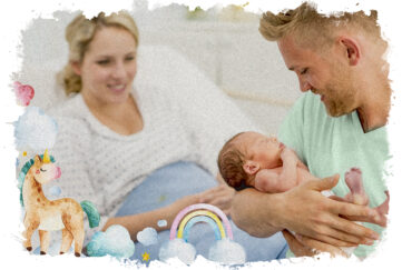 A new father holds is newborn in his arms as he looks down smiling at the baby. His wife is sitting up in her hospital bed in the background. She is wearing a hospital gown and smiling as she watches her husband enjoy a moment with his new son. The infant is just wearing a diaper as dad enjoys some skin-on-skin time.