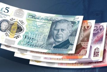 Image feature a five pound note with King Charles' face on it. This note is stacked upon a ten, a 20 and a 50 pound note, also with King Charles' face on them.