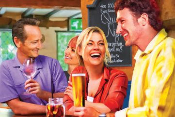 Characters from the serial, Evelyn and Simon with Lynda and Alex in a bar.