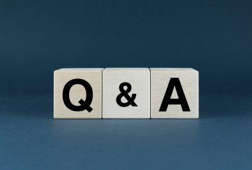 The letters Q and A on a grey background.