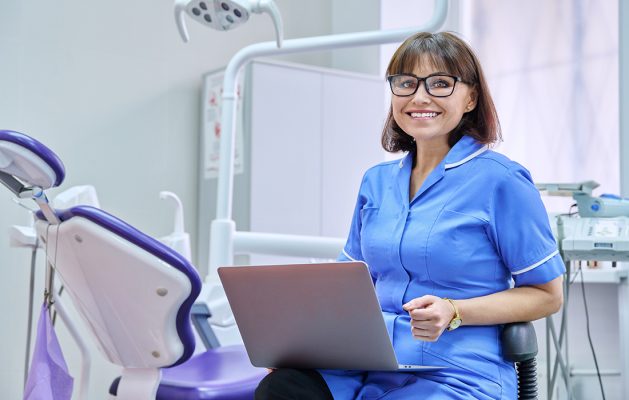 A nurse sitting with a laptop to go with 76 years of the NHS