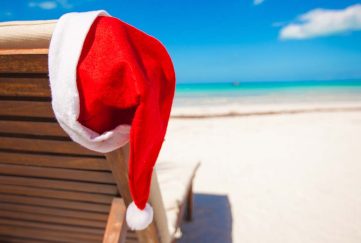 Red Santa hat on a sun lounger on the beach