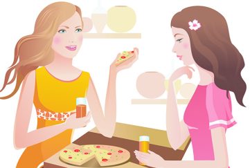 Two ladies with pizza in a cafe