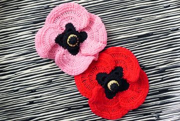 Two poppies, one pink, one red, worked using our free crochet pattern