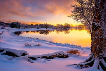 Sunset over a snow covered landscape in lowlands Scotland to illustrate our uplifting poem