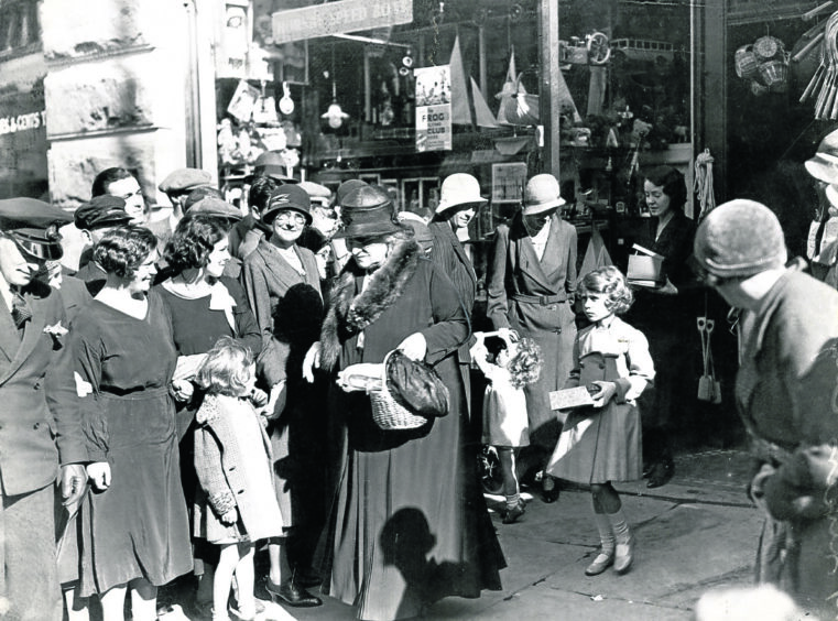 Princess Elizabeth with her grandmother shopping in Webster's in Whitehall Crescent in 1933.