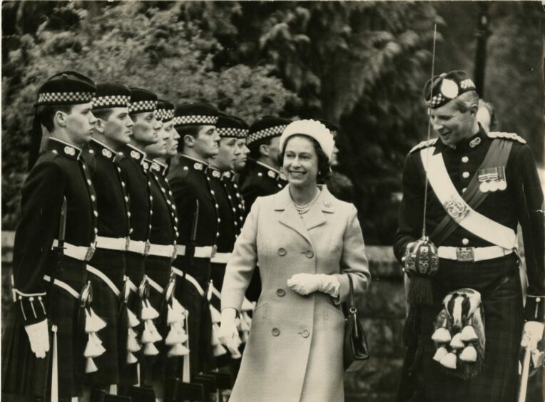 The Queen inspects the Royal Guard at the gates of Balmoral Castle during a holiday. Picture by DCT Media, 1970.