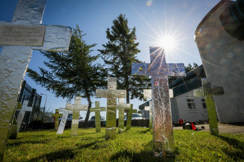 A ceremony to mark International Overdose Awareness Day with arrangements of empty shoes and crosses to mark drug deaths in Dundee.