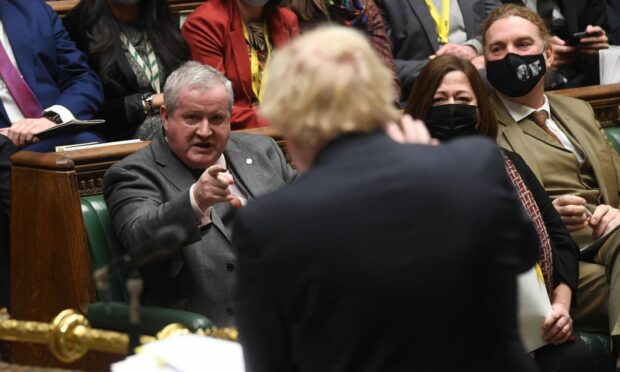 SNP MP Ian Blackford engaged in discussion with Boris Johnson.