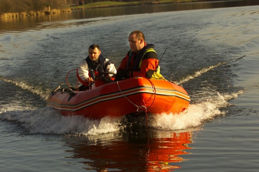 Police conduct a sweep of Forfar Loch following the disappearance of Mr Murray.