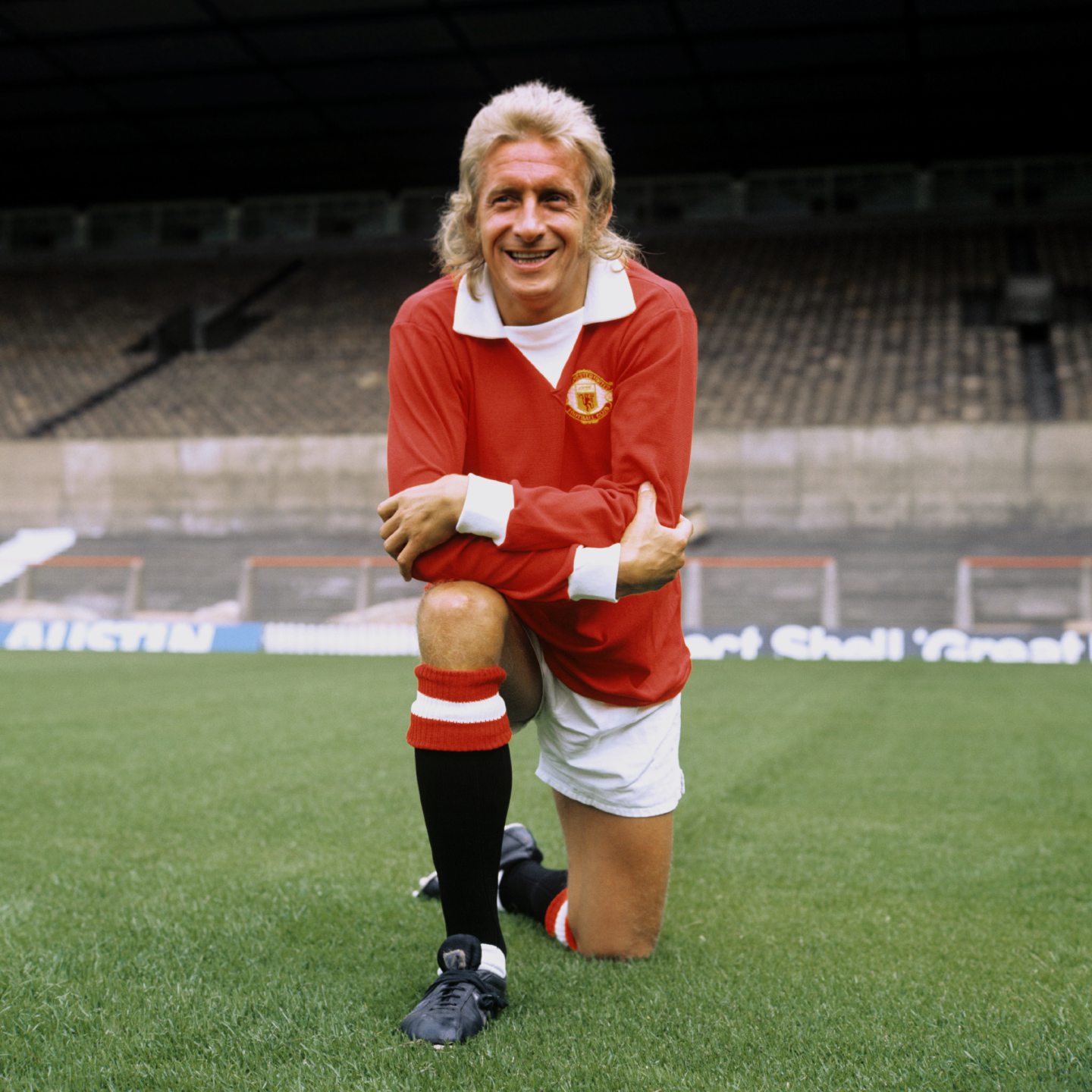 Denis Law poses for a picture in his Manchester United kit