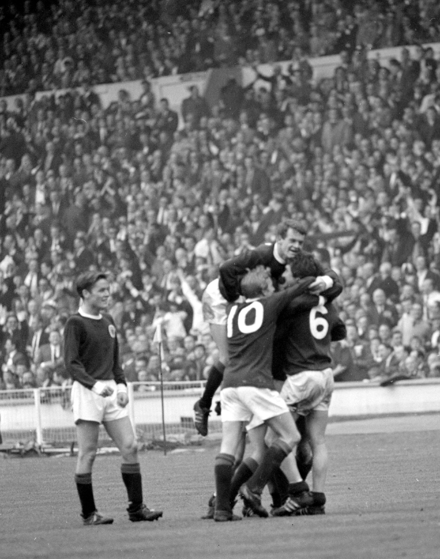 Bobby Lennox is mobbed by his team-mates after the winger had scored Scotland's second goal in the international against England at Wembley.