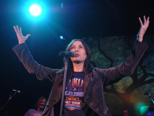 Natalie Imbruglia performs onstage during a concert at the Shepherds Bush Empire in 2005 (PA)