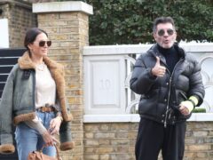 Simon Cowell and his partner Lauren Silverman leave their home in London’s Holland Park (James Manning/PA)