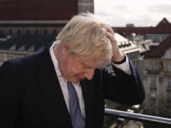 Prime Minister Boris Johnson rubbing his hair to get ready for a interview during the Munich Security Conference in Germany where he is meeting with world leaders to discuss tensions in eastern Europe. Picture date: Saturday February 19, 2022.