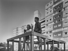 Children playing on a climbing frame on the Doddington Estate, Battersea, with a 10-storey and 13-storey block of flats behind in 1971 (Historic England Archive/John Laing Photographic Collection)