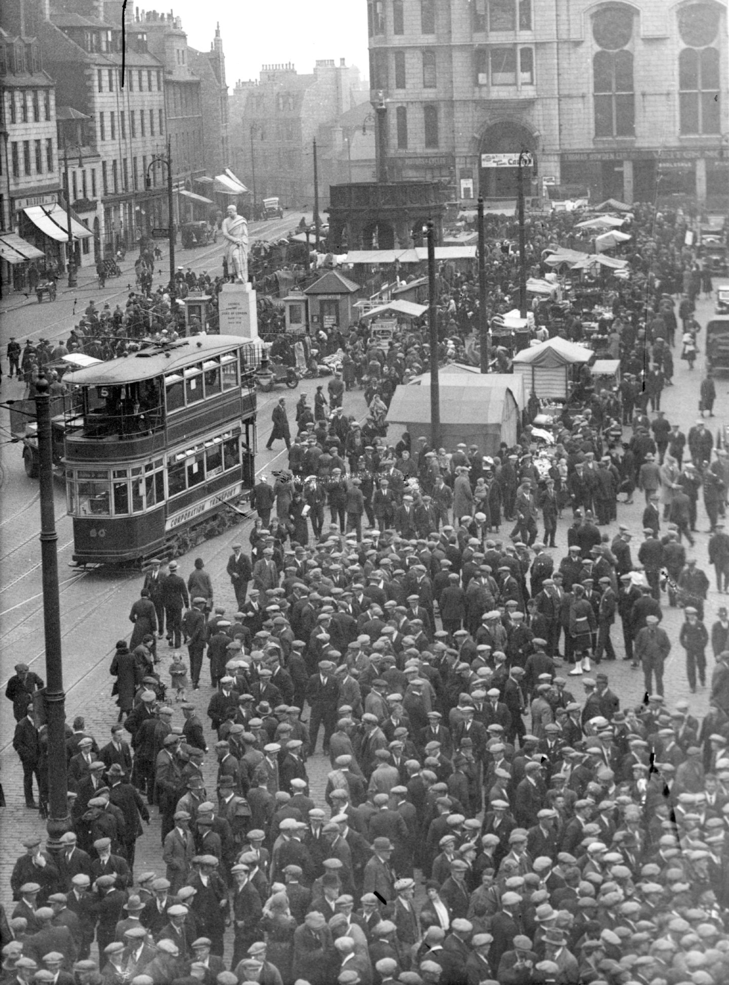 A black and white shot of an Aberdeen tram amid crowds