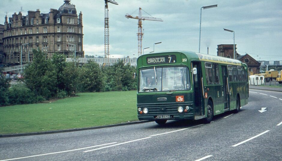 A bus heads up to the High Street while work starts on Tayside House in the background.