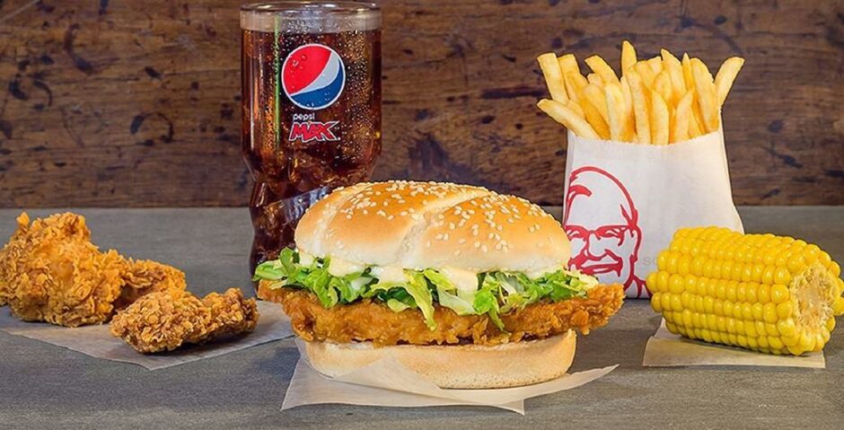 KFC's chicken fillet burger with a selection of sides and a drink.
