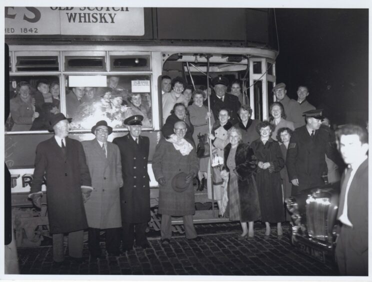 Happiness is tinged with sadness as crowds pose in front of the last tram to Woodside in November 1955.