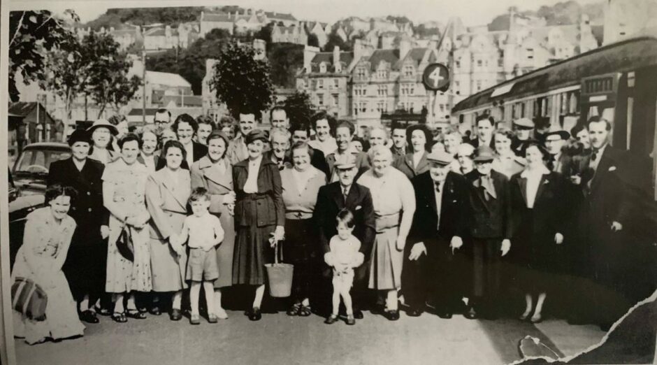 When the Evening Citizen TV train came to Oban in 1956. Ken MacIntyre aged almost 4 is in the centre, and his mother is crouching, far left.