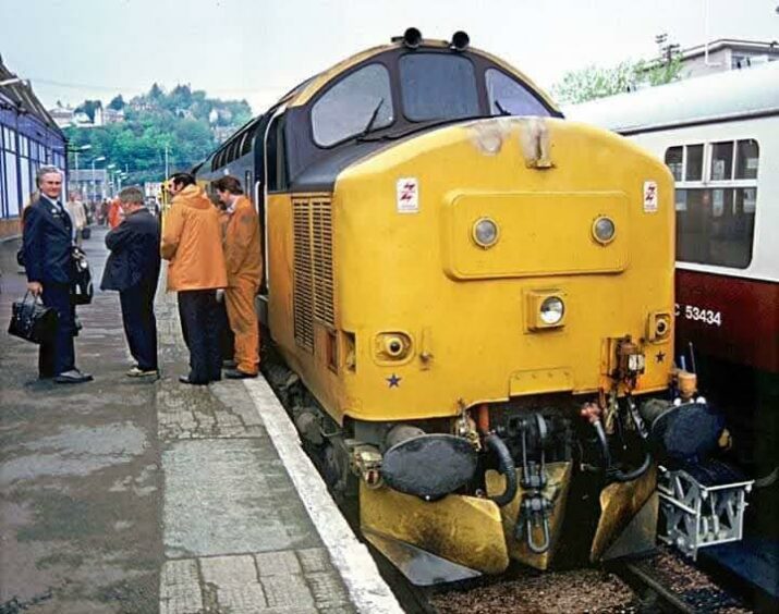 Far left, Ken's father driver Kenneth MacIntyre by a Class 37 locomotive at Oban station in the 1980s.
