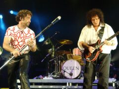 New frontman Paul Rodgers (left) and Brian May of Queen perform live on stage (Yui Mok/PA)