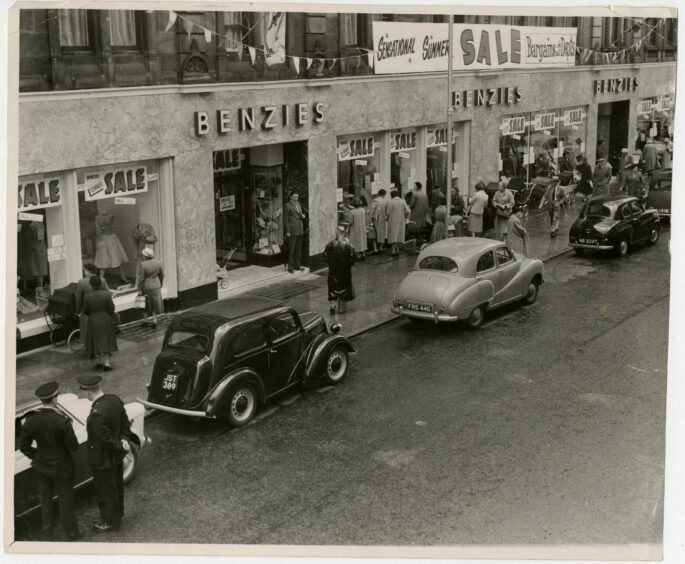 Bargain hunters outside Benzie's, Inverness during the annual summer sales in 1959.  People started queuing early, and even slept in the street the night before. AJL.