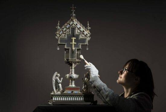 Special collections manager Dr Hannah Thomas cleans a True Cross relic at The Bar Convent Living Heritage Centre in York, as the convent marks Easter with the discovery of previously unseen authentication and provenance documents. This documentation, along with new research, shows a likely explanation as to how the relic eventually arrived at the convent in 1792 and has enabled the convent to trace elements of the history of the relic which have been a mystery since the 19th Century. Danny Lawson/PA Wire.