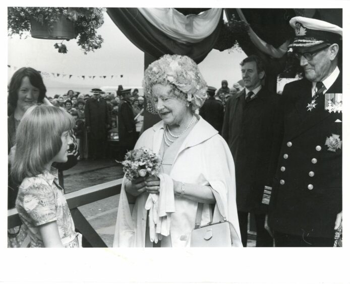 The opening of Kessock Bridge. The Queen Mother is presented with a posie by Dawnmaree Ross, 8, of North Kessock, during her visit on August 6 1982.