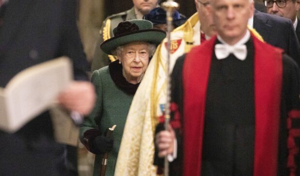 A photo of Queen Elizabeth II wearing a green dress and hat.