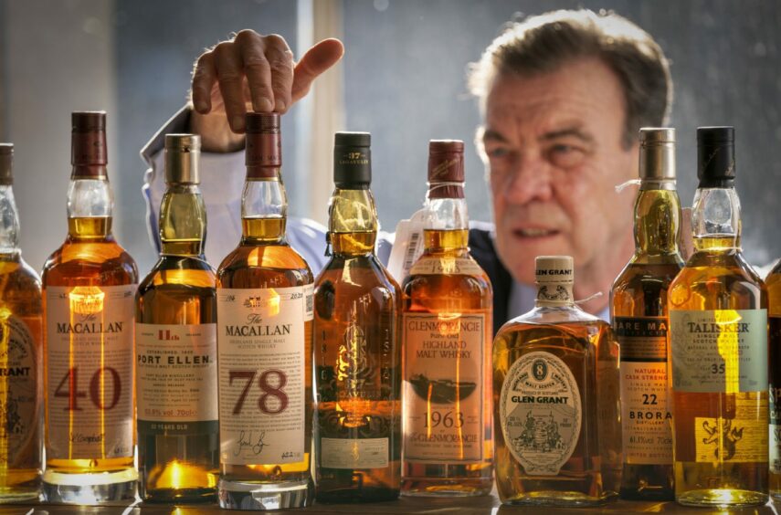 Bonhams' Head of Whisky Martin Green inspects a bottle of one of the oldest known Macallan Scotch Whiskys ever produced, The Macallan-78 year old, which leads Bonhams Whisky sale in Edinburgh on Wednesday. Picture by PA.