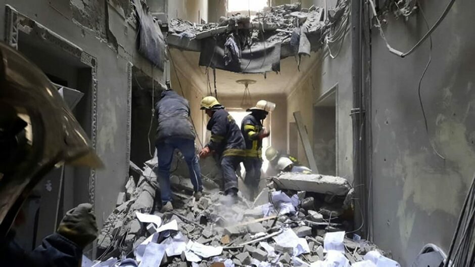 This handout photo released by Ukrainian Emergency Service shows emergency service personnel inspecting the damage inside the City Hall building in Kharkiv, Ukraine. Picture by AP.