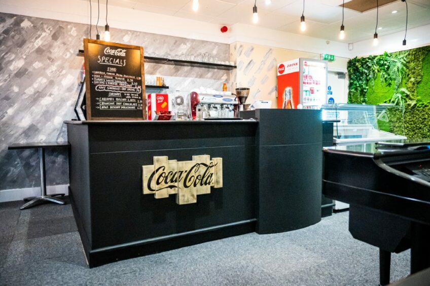 The black counter is adorned with Coca Cola branding 