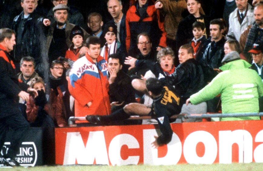 Cantona jumps into the crowd to kick a fan.
