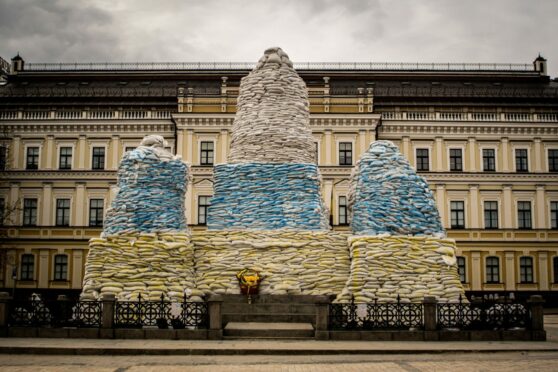 Bags of sand surround and protect city monuments in Kyiv from Russian warfare. Nicola Marfisi/AGF/Shutterstock.