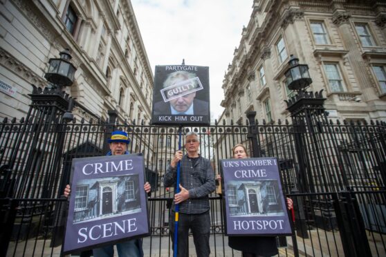 Protesters stage a demonstration outside Downing Street, calling on UK Prime Minister Boris Johnson and Chancellor of the Exchequer Rishi Sunak to resign. Both Johnson and Sunak were fined by Scotland Yard for breaking Covid-19 restrictions by attending parties in Downing Street. Tayfun Salci/ZUMA Press Wire/Shutterstock.