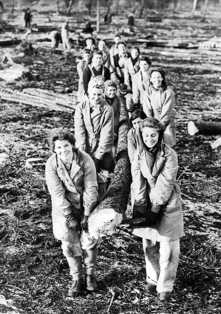 Women carrying a tree log