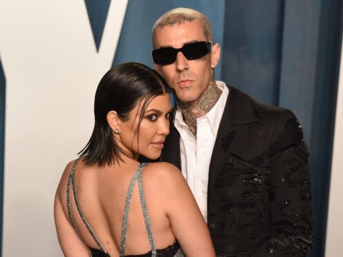 Kourtney Kardashian and Travis Barker attending the Vanity Fair Oscar Party (PA)