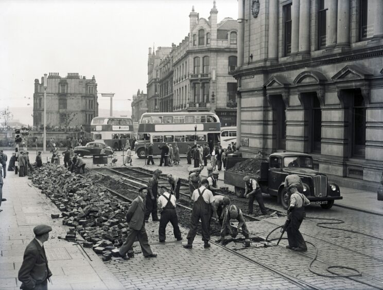 End of the line: Men hard at work removing the tram lines from Aberdeen's Union Terrace in the 1950s.